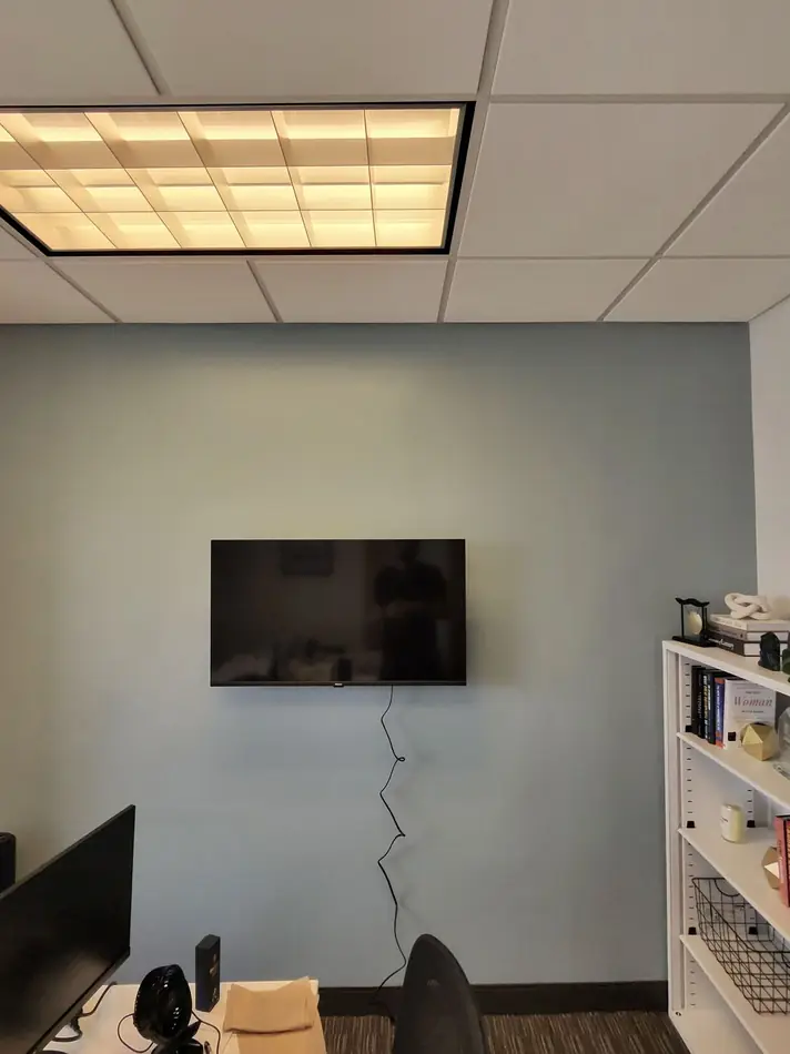 Laser level line projected on a wall before drilling for a TV mount